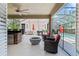Relaxing screened patio features outdoor kitchen, a bar, comfortable seating, and a fire pit, perfect for outdoor entertaining at 5955 Caldera Ridge Dr, Lithia, FL 33547