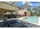 Inviting screened-in pool area with lounge chairs, outdoor kitchen and covered patio, perfect for relaxation and entertaining at 5955 Caldera Ridge Dr, Lithia, FL 33547