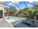Relax by the in-ground screened pool with cozy lounge chairs, a decorative rug, and a sleek black safety fence for peace of mind at 5955 Caldera Ridge Dr, Lithia, FL 33547
