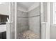 This walk-in shower features a built-in seat and stone floor at 5955 Caldera Ridge Dr, Lithia, FL 33547