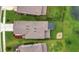 Aerial view of the property with a fire pit, pergola, well-maintained lawn, and beautiful landscaping at 6555 Kenava Loop, Palmetto, FL 34221