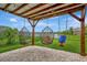 Backyard featuring a covered patio with swings and a view of the pond at 6555 Kenava Loop, Palmetto, FL 34221