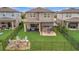 Wide backyard with covered patio, pergola with swings, and firepit area, great for relaxation at 6555 Kenava Loop, Palmetto, FL 34221