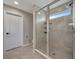 Modern bathroom featuring glass-enclosed shower with tile surround, built-in shelving, and a window at 6555 Kenava Loop, Palmetto, FL 34221
