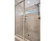 Modern glass-enclosed shower boasts updated fixtures, a window, and sleek shelving at 6555 Kenava Loop, Palmetto, FL 34221