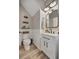 Well-lit half bath with modern fixtures, wainscoting, and wood-look tile flooring at 6555 Kenava Loop, Palmetto, FL 34221