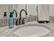 Bathroom features a granite countertop, white sink, and matte black faucet and fixtures at 6555 Kenava Loop, Palmetto, FL 34221