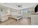 Bedroom features wood floors, a ceiling fan, shuttered windows, and a bright, airy feel at 6555 Kenava Loop, Palmetto, FL 34221