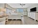 Bedroom features wood floors, a ceiling fan, shuttered windows, and bright, airy feel at 6555 Kenava Loop, Palmetto, FL 34221