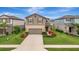 Lovely two-story home featuring a well-manicured lawn, colorful landscaping, and inviting curb appeal at 6555 Kenava Loop, Palmetto, FL 34221