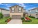 Well-kept two-story home with a landscaped front yard, showcasing curb appeal and a welcoming entrance at 6555 Kenava Loop, Palmetto, FL 34221