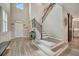 Bright foyer with hardwood floors, staircase, accent wall, and view of kitchen at 6555 Kenava Loop, Palmetto, FL 34221