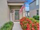 Welcoming front door with American flag, wreath, and attractive landscaping at 6555 Kenava Loop, Palmetto, FL 34221