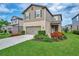 Charming two-story home with well-manicured lawn and colorful flower beds at 6555 Kenava Loop, Palmetto, FL 34221