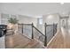 Bright hallway with wood floors, decorative banister, and a shiplap accent wall at 6555 Kenava Loop, Palmetto, FL 34221