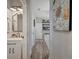 Hallway view features decorative painting, modern lighting, and bathroom access at 6555 Kenava Loop, Palmetto, FL 34221