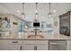 Bright kitchen featuring island with granite countertops, stainless steel appliances, and an open layout at 6555 Kenava Loop, Palmetto, FL 34221