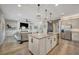Open concept home featuring a kitchen with an island and a cozy living room at 6555 Kenava Loop, Palmetto, FL 34221