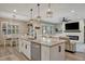 Bright eat-in kitchen featuring an island with granite countertops and stainless steel appliances at 6555 Kenava Loop, Palmetto, FL 34221