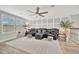 Comfortable living room featuring a ceiling fan, shutters, and a sectional sofa at 6555 Kenava Loop, Palmetto, FL 34221