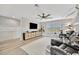 Spacious living room featuring a ceiling fan, media center, plantation shutters, and a comfortable seating area at 6555 Kenava Loop, Palmetto, FL 34221