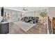 Open floor plan living room with wood floors, ceiling fan, shutters, and comfortable seating at 6555 Kenava Loop, Palmetto, FL 34221