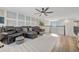 Large living room with comfortable seating, ceiling fan, and railing view at 6555 Kenava Loop, Palmetto, FL 34221