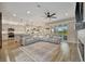 Open-concept living room with hardwood floors, modern sofa, and fireplace feature at 6555 Kenava Loop, Palmetto, FL 34221