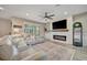 Cozy living room with a modern fireplace feature, hardwood floors, and a comfortable sofa at 6555 Kenava Loop, Palmetto, FL 34221