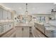 Open concept home featuring a kitchen with an island and a cozy living room at 6555 Kenava Loop, Palmetto, FL 34221