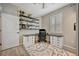 Home office featuring built-in shelving, ample storage, and natural light from shuttered windows at 6555 Kenava Loop, Palmetto, FL 34221
