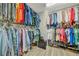 Large walk-in closet with hanging racks and shelving provides storage for clothing and shoes at 6555 Kenava Loop, Palmetto, FL 34221