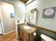 Bright bathroom featuring a decorative backsplash and updated vanity with ample counter space at 713 Rustic Oaks Dr, Palm Harbor, FL 34684