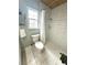 The bathroom features tile floors, a window, a white toilet, and a tiled shower with a curtain at 713 Rustic Oaks Dr, Palm Harbor, FL 34684
