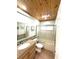 Bathroom features a granite vanity, glass shower door, and updated fixtures at 713 Rustic Oaks Dr, Palm Harbor, FL 34684