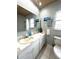 The bathroom features tile floors, a white vanity and toilet, a medicine cabinet, and decor at 713 Rustic Oaks Dr, Palm Harbor, FL 34684