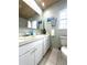 Charming bathroom featuring a decorative backsplash and updated vanity with ample counter space at 713 Rustic Oaks Dr, Palm Harbor, FL 34684