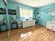 Bright bedroom with hardwood floors, decorative decor, and a large window that fills the room with natural light at 713 Rustic Oaks Dr, Palm Harbor, FL 34684