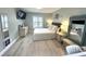 The bedroom features wood-look floors, a TV, white wicker furniture, and coastal-themed decorations at 713 Rustic Oaks Dr, Palm Harbor, FL 34684