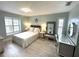 The bedroom features wood-look floors, a vanity area, coastal-themed decor, and shuttered windows at 713 Rustic Oaks Dr, Palm Harbor, FL 34684