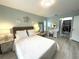 The bedroom features wood-look floors, a vanity area, coastal-themed decor, and a walk-in closet at 713 Rustic Oaks Dr, Palm Harbor, FL 34684