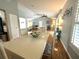 Bright dining area showcasing hardwood floors and seamlessly connecting to the living room and kitchen at 713 Rustic Oaks Dr, Palm Harbor, FL 34684