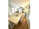 Open-concept dining room featuring wood floors, view of the living room, and access to other rooms at 713 Rustic Oaks Dr, Palm Harbor, FL 34684