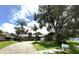 Charming single-story home with a well-manicured lawn, mature trees, and inviting curb appeal at 713 Rustic Oaks Dr, Palm Harbor, FL 34684