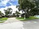 Inviting one-story home with a well-maintained lawn and mature landscaping at 713 Rustic Oaks Dr, Palm Harbor, FL 34684
