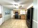 Modern kitchen featuring stainless steel appliances, granite countertops, and ample cabinet space at 713 Rustic Oaks Dr, Palm Harbor, FL 34684