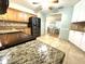 The kitchen features granite counters, wood cabinets, stainless steel appliances, and tile floors at 713 Rustic Oaks Dr, Palm Harbor, FL 34684