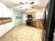 Bright kitchen featuring stainless steel appliances, updated countertops, tile floors, and ample storage space at 713 Rustic Oaks Dr, Palm Harbor, FL 34684