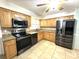Modern kitchen with stainless steel appliances, stylish cabinetry, and granite countertops, perfect for cooking at 713 Rustic Oaks Dr, Palm Harbor, FL 34684
