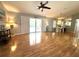 Open-concept living area featuring beautiful hardwood floors, abundant natural light, and easy access to outdoor spaces at 713 Rustic Oaks Dr, Palm Harbor, FL 34684
